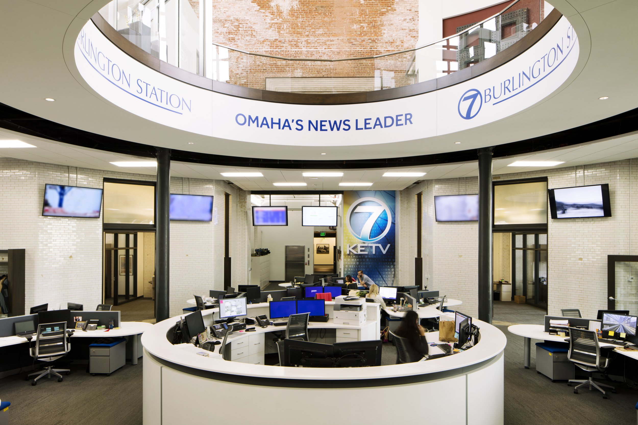 News station interior showing desk and monitors.