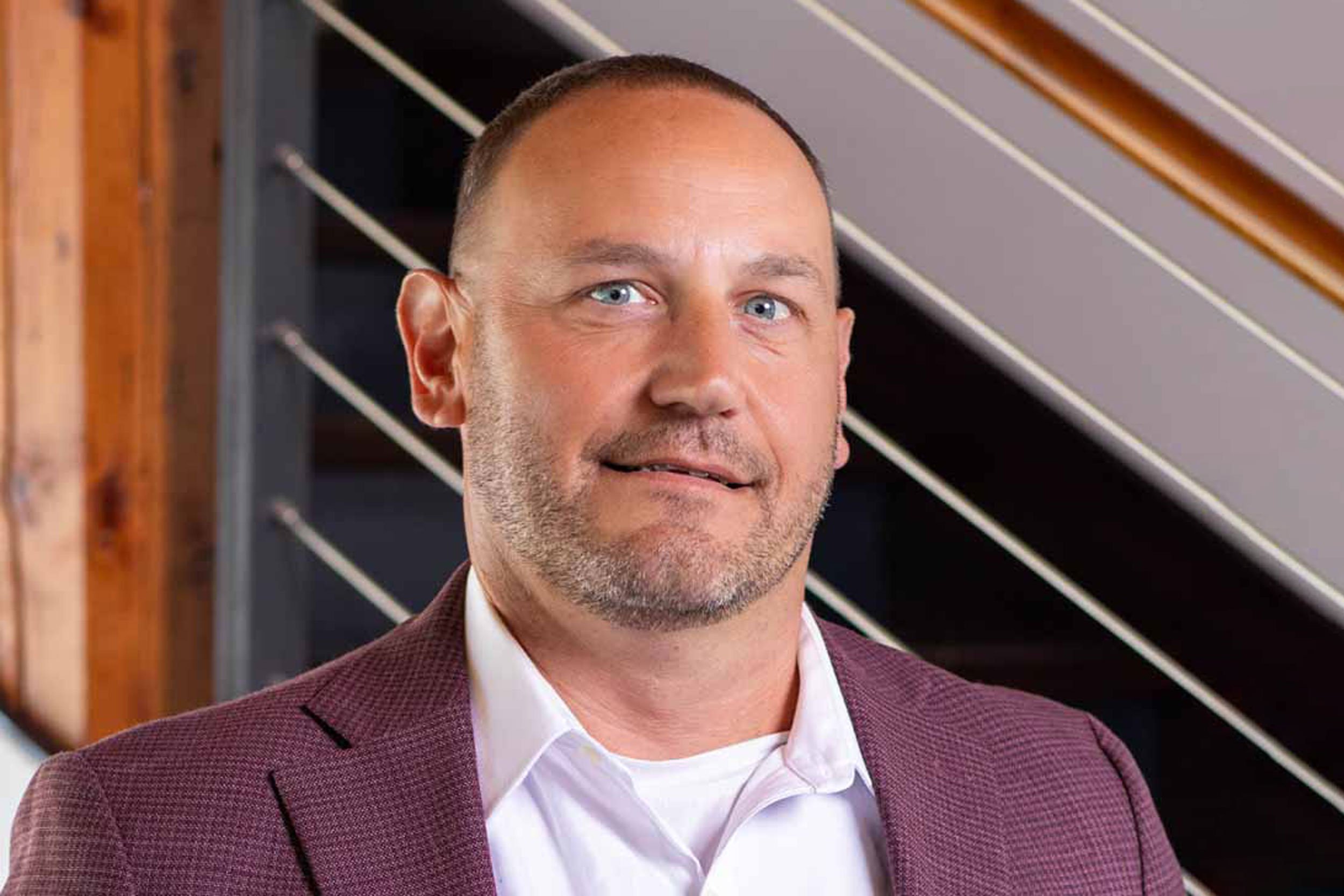 Greg McClure in maroon sport coat